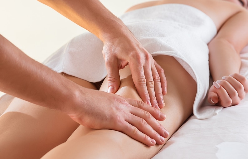 detail hands massaging human calf muscle
