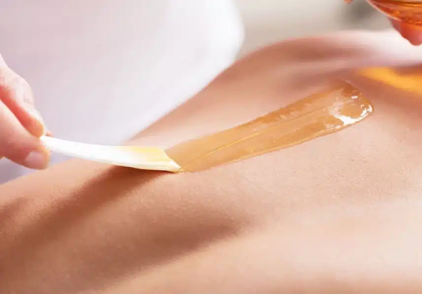 stock photo close up of a woman waxing man s chest with wax strip 609056153 transformed