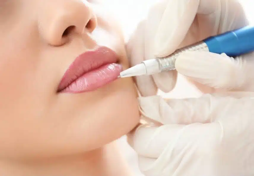 stock photo young woman having permanent makeup on lips in beautician salon 687732997 transformed 1